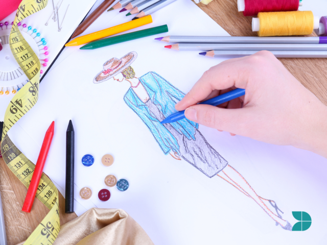 A fashion designer drawing a sketch with wax pencils.
